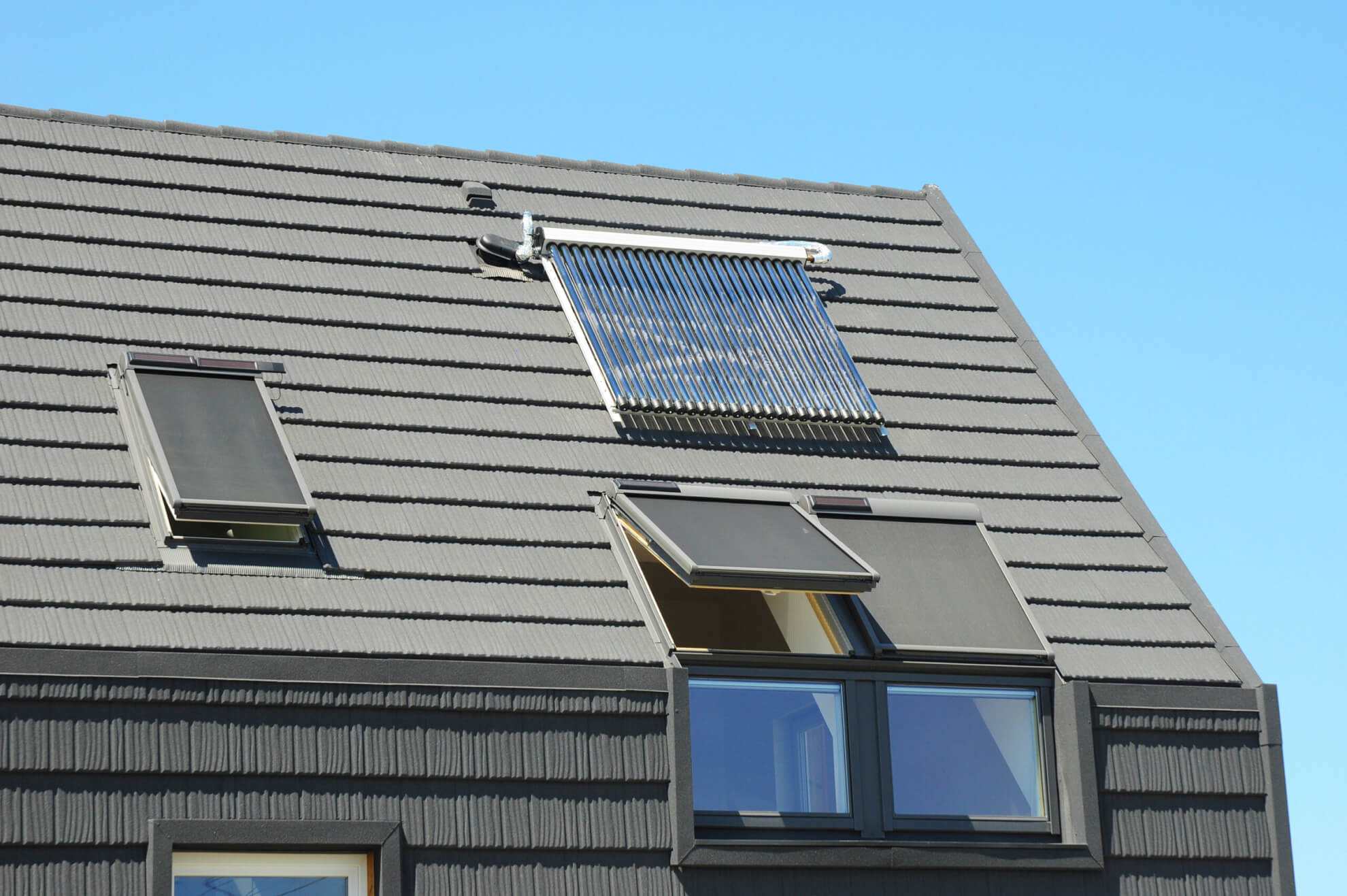 Modern House Roof with Solar Water Heater, Solar Panels and Skylights, Beautiful New Contemporary House with Solar Panels. Solar water panel heating.